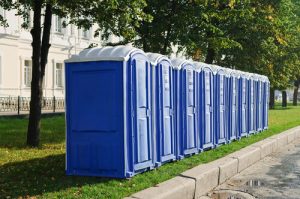 line of porta potties in the grass